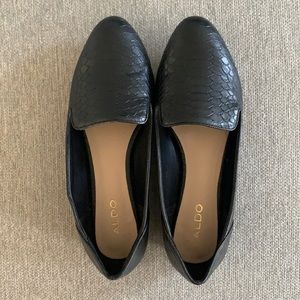 Black loafer flats with crocodile skin texture